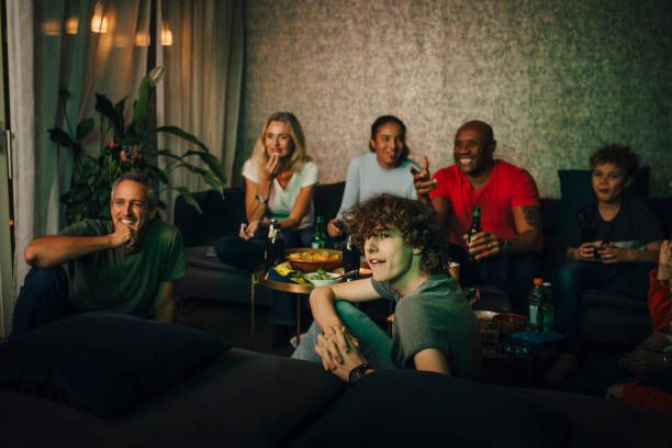 Friends and family watching live sports on IPTV lifetime subscription service at night