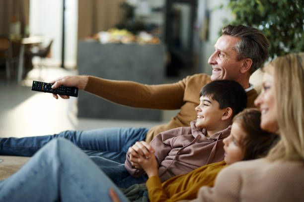 Happy family watching HD television at home using an IPTV player